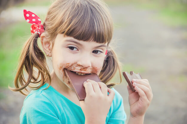 sweet-toothed-child-eats-chocolate-selective-focus_73944-7047.jpg